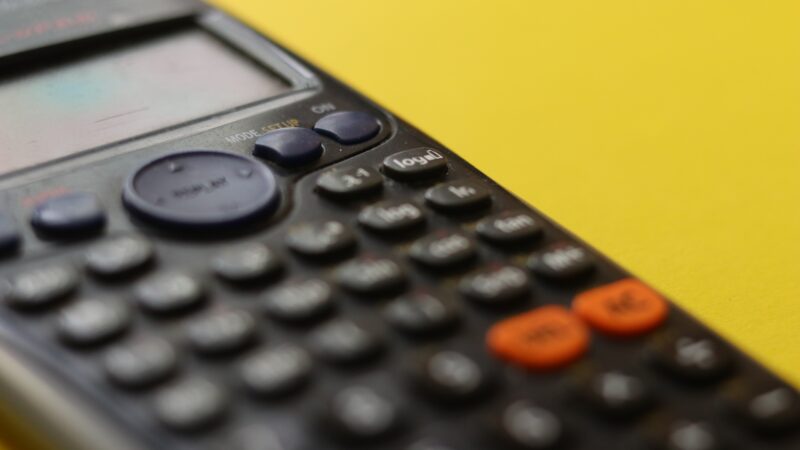 black remote control on yellow surface