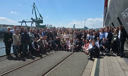 Darstellung eines Gruppenbildes ain einen Container Hafen, auf dem alle Teilnehmer des ETW Annual Meetings abgebildet sind